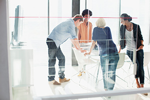 Business people meeting in sunny conference room