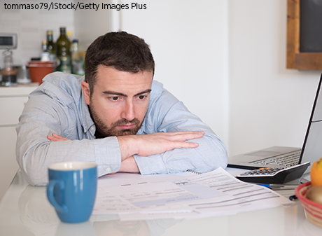 Depressed man looking at finances
