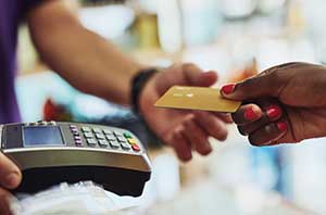 woman with credit card at register