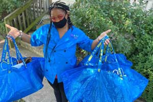 Neshanta Larry holds up food delivery bags