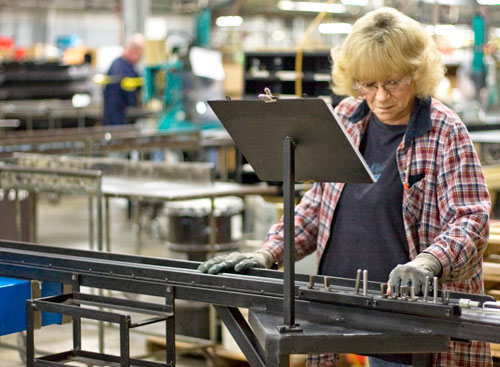 At Orscheln Products, Kay Nickerson checks lengths of parking brake cables.| St. Louis Fed