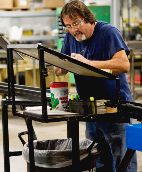 At the Orscheln Products plant in Moberly that makes conduit for parking brake cable, Darrin Heaston fills out quality-assurance paperwork. | St. Louis Fed