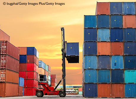 crane lifting container in yard