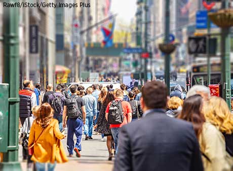 People walking on sidewalks in New York City.